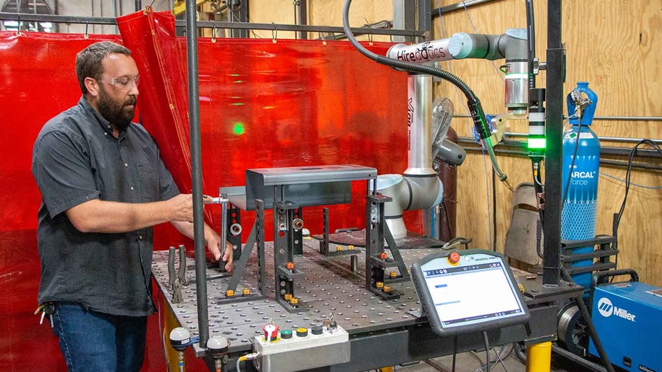 Man checking welding application fixture